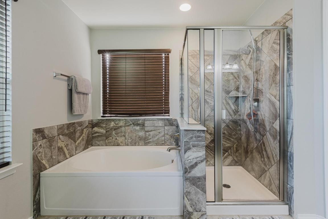 1420 Crested Butte Way Georgetown, TX 78626 - Photo 24 of 40 Primary Bathroom with a garden tub and a stall shower