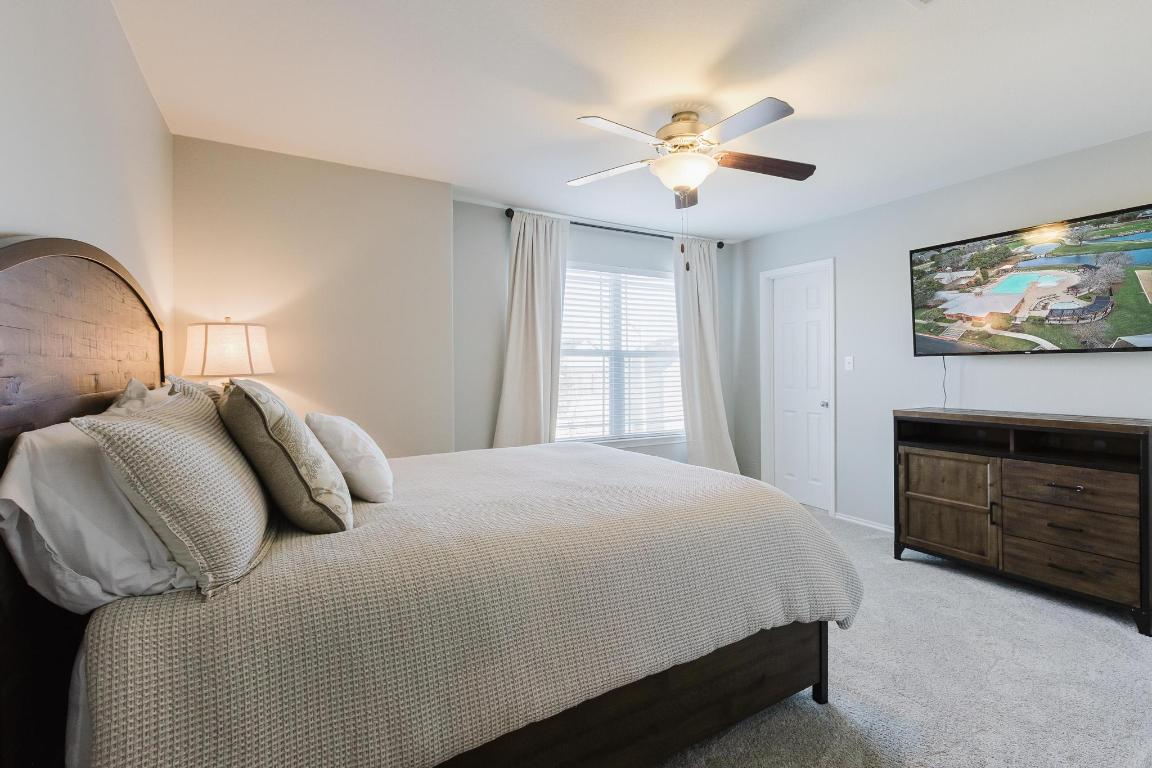 1420 Crested Butte Way Georgetown, TX 78626 - Photo 29 of 40 Bedroom 2 with light carpet and a ceiling fan