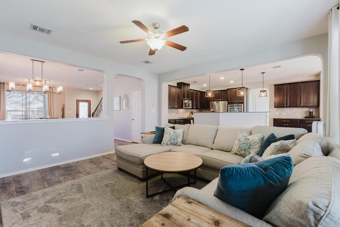 1420 Crested Butte Way Georgetown, TX 78626 - Photo 7 of 40 Living area with arched walkways, wood finished floors, ceiling fan, and recessed lighting