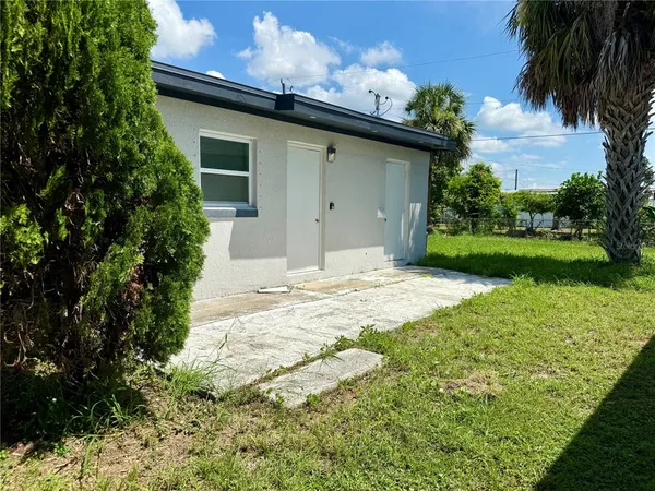 a view of a house with a yard and a garden