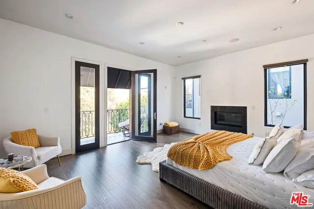 a bedroom with a bed and glass window