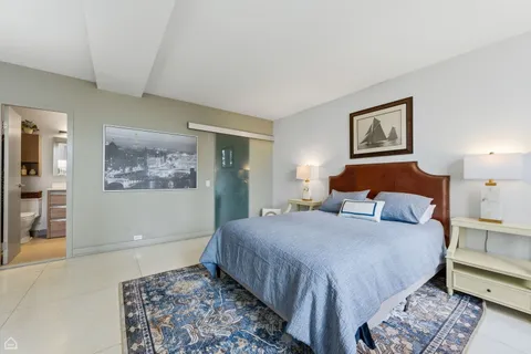 a bedroom with bed and painting on the wall