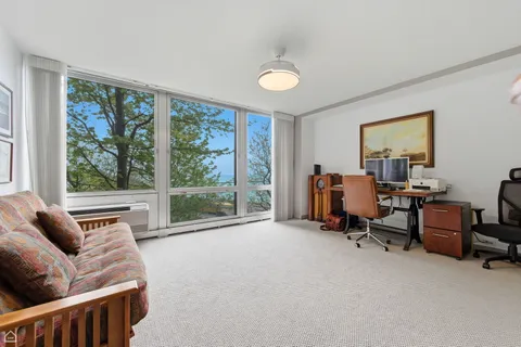 a view of a livingroom with workspace and a couch