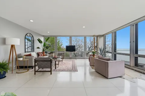 a living room with furniture and large windows