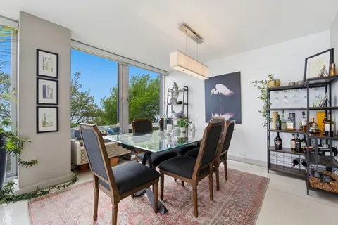 a view of a dining room with furniture and window