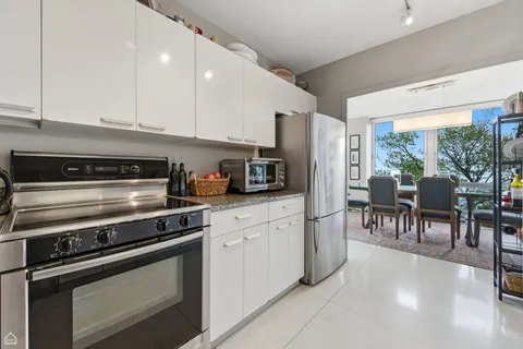 a kitchen with stainless steel appliances a stove a sink and a refrigerator
