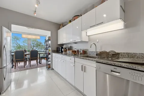 a kitchen with granite countertop a sink and cabinets