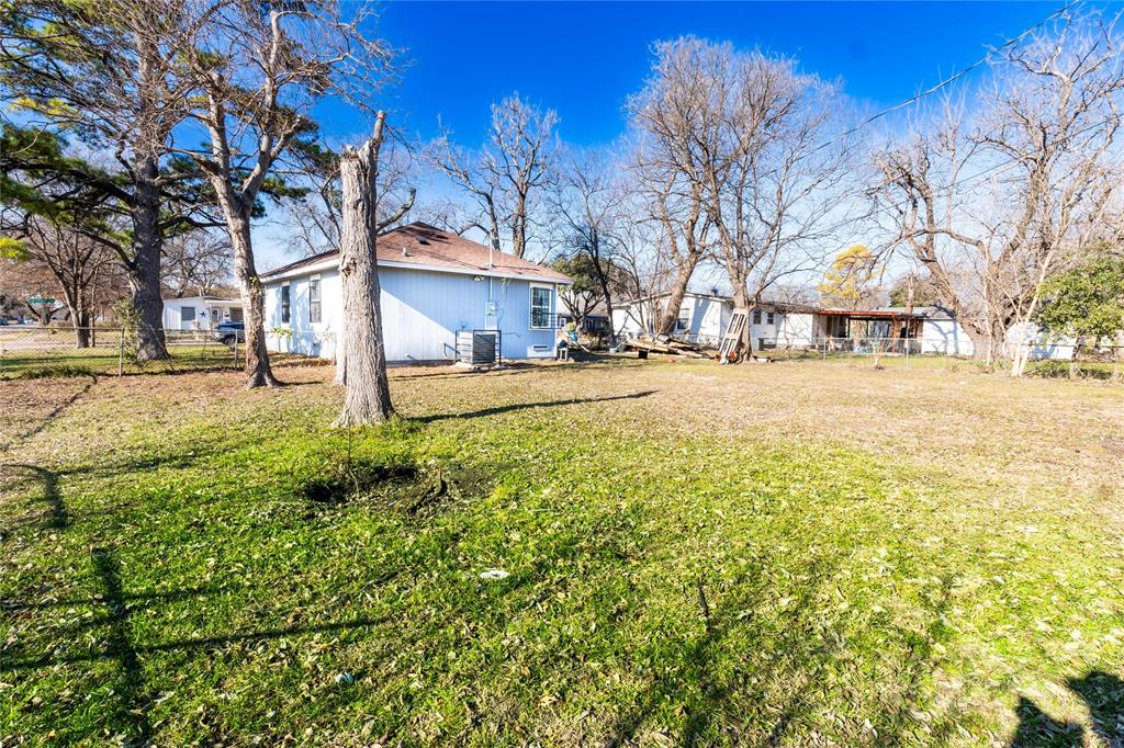 4732 Springer Street Dallas, TX 75216 - Photo 3 of 11 a white house that has a tree in front of it
