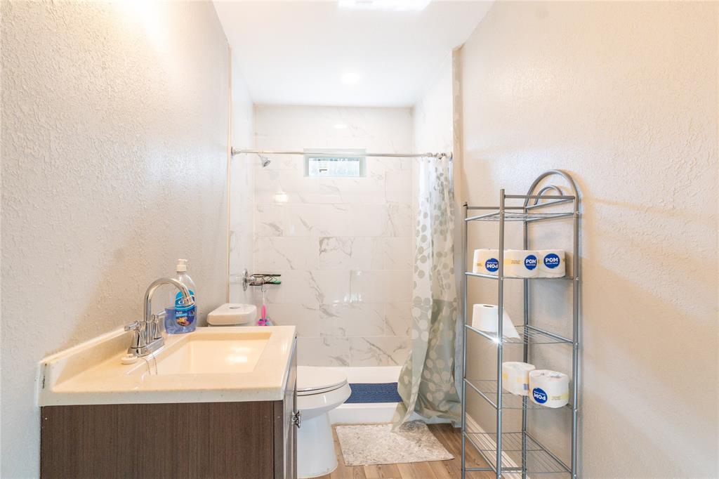 4732 Springer Street Dallas, TX 75216 - Photo 5 of 11 a bathroom with a sink a toilet and shower