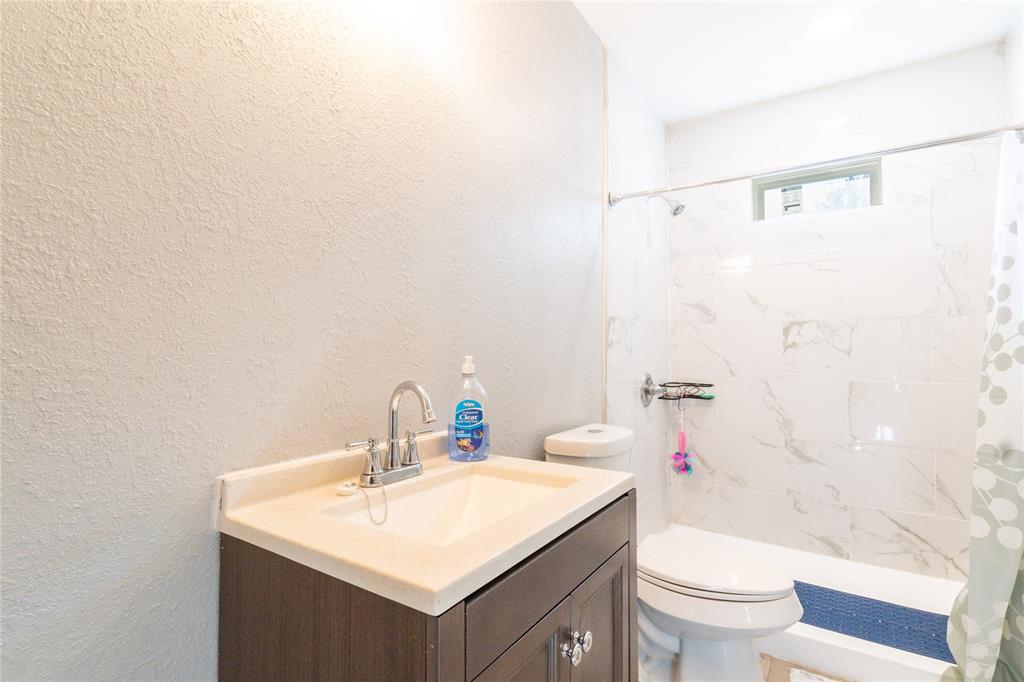 4732 Springer Street Dallas, TX 75216 - Photo 6 of 11 a bathroom with a sink toilet and shower
