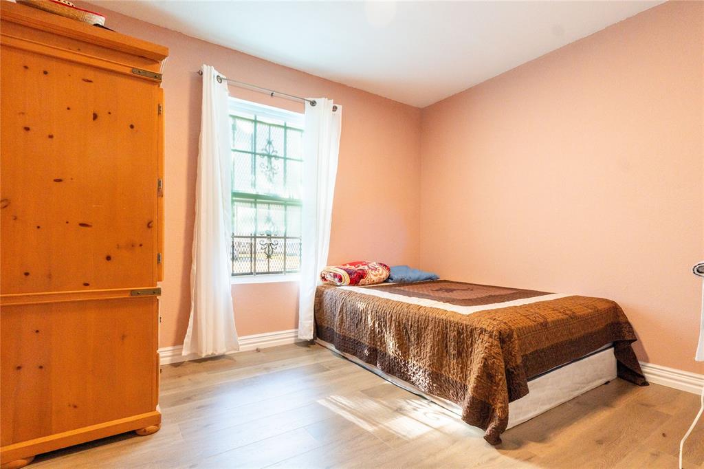 4732 Springer Street Dallas, TX 75216 - Photo 7 of 11 a bedroom with a bed and a window