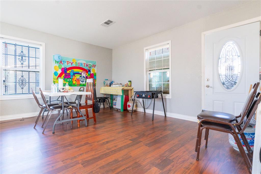 4732 Springer Street Dallas, TX 75216 - Photo 10 of 11 a view of a dining room with furniture a chandelier and wooden floor
