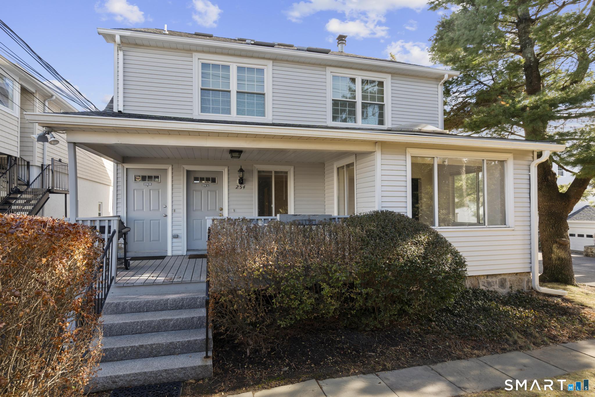 254 Seaside Avenue, Unit A Stamford, CT 06902 - Photo 1 of 28 a view of a house with wooden fence and large windows
