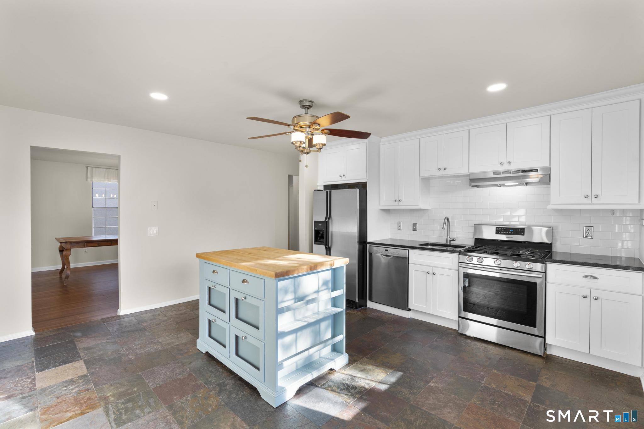 254 Seaside Avenue, Unit A Stamford, CT 06902 - Photo 13 of 28 a kitchen with stainless steel appliances granite countertop a stove a refrigerator and a sink