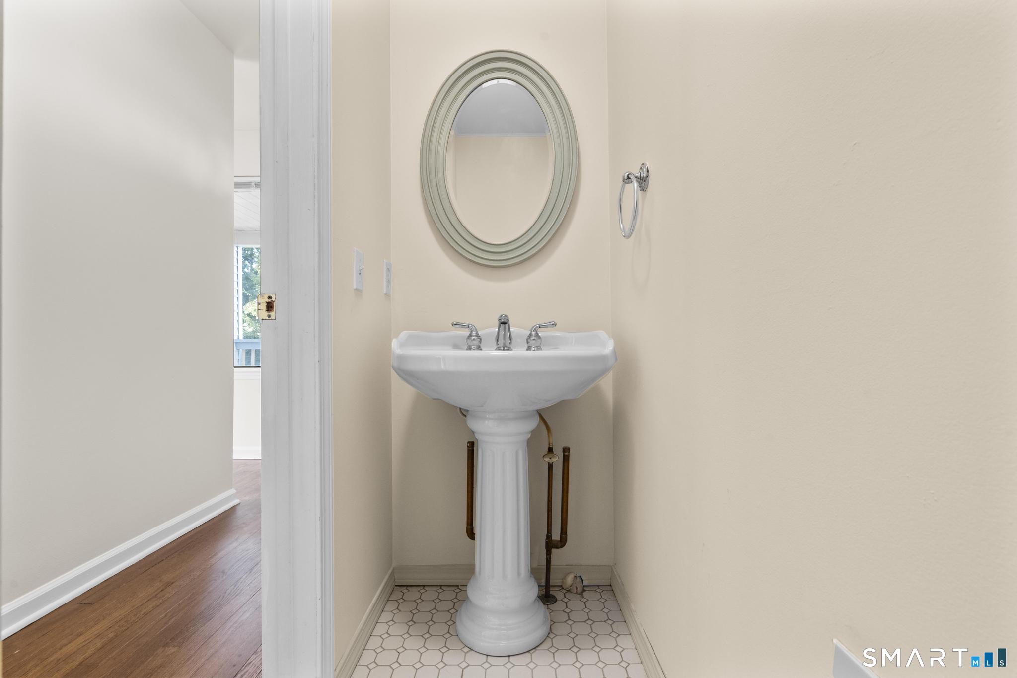 254 Seaside Avenue, Unit A Stamford, CT 06902 - Photo 15 of 28 a bathroom with a sink and a mirror