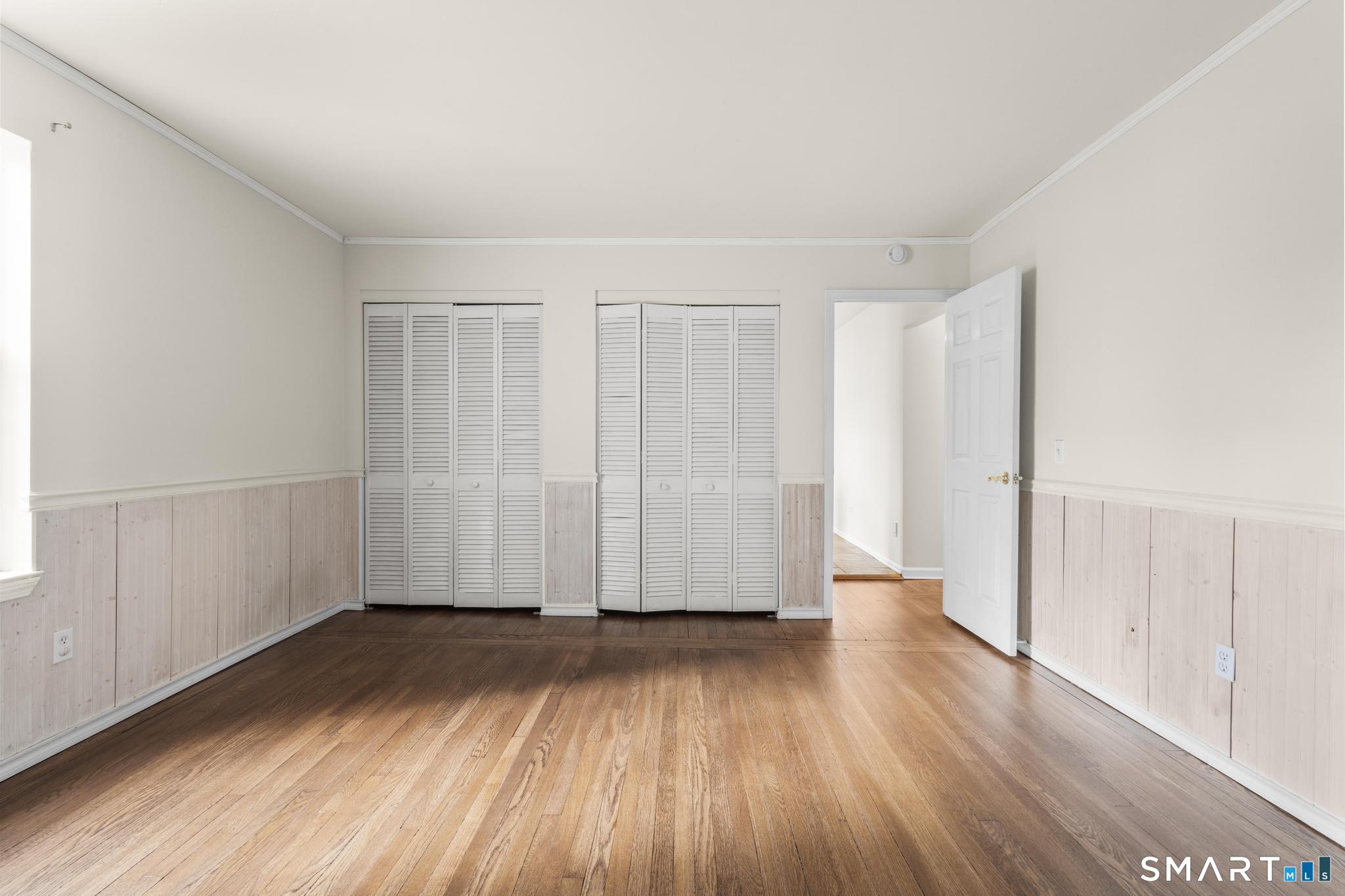 254 Seaside Avenue, Unit A Stamford, CT 06902 - Photo 17 of 28 an empty room with wooden floor and windows