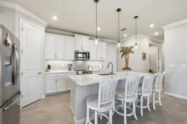a kitchen with appliances a sink and cabinets