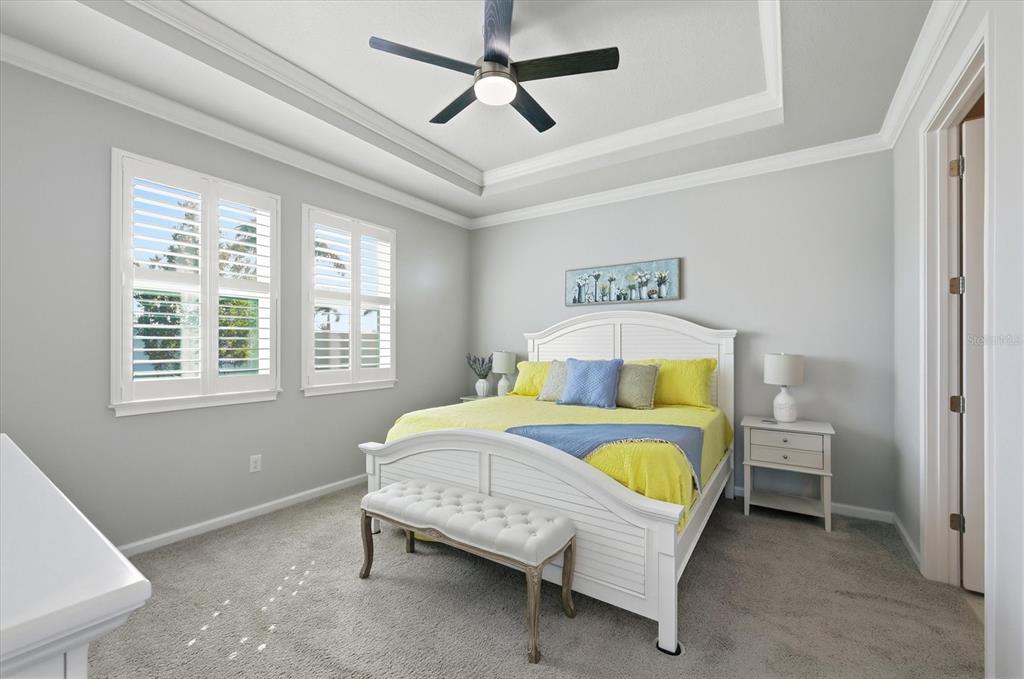 12333 Asana Court Venice, FL 34293 - Photo 16 of 58 a bed room with a bed and a chandelier