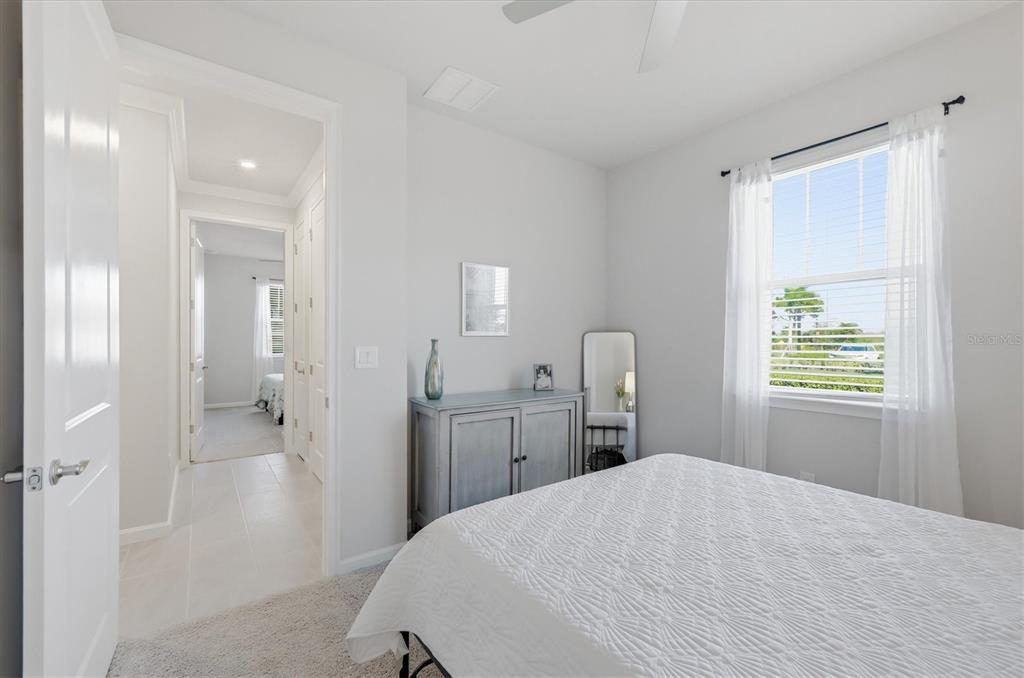 12333 Asana Court Venice, FL 34293 - Photo 20 of 58 a bedroom with a bed and a dresser
