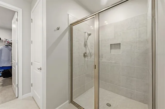 a bathroom with double vanity sinks a mirror and a shower