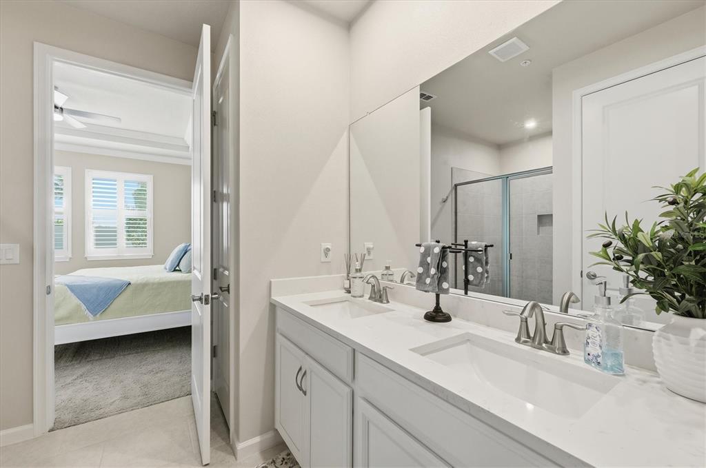 12333 Asana Court Venice, FL 34293 - Photo 25 of 58 a en suite bathroom with double vanity and a mirror