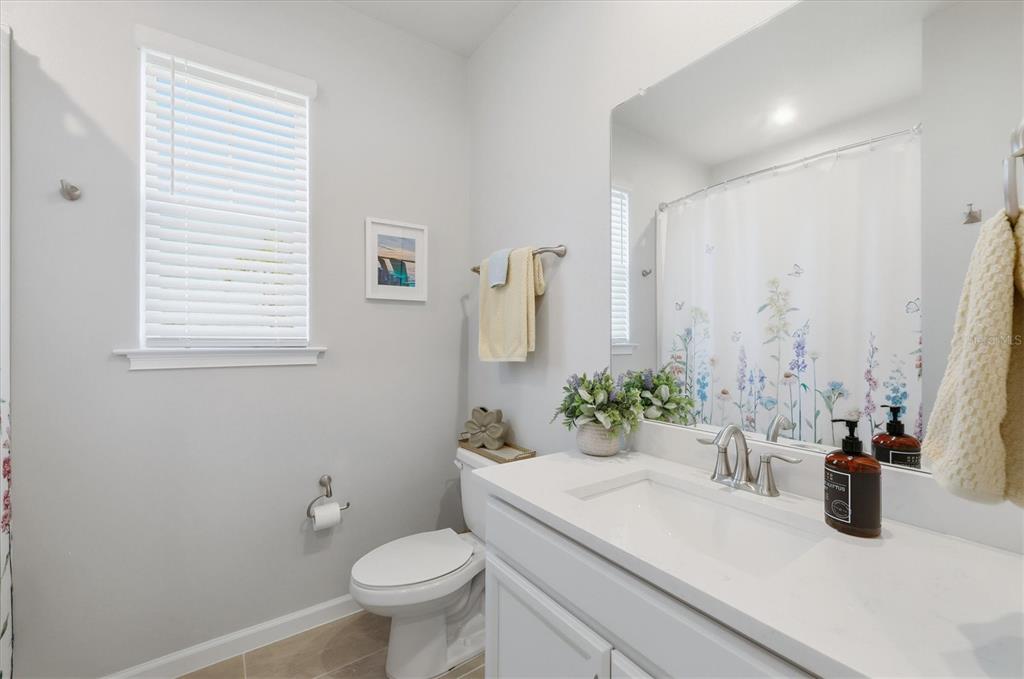 12333 Asana Court Venice, FL 34293 - Photo 26 of 58 a bathroom with a sink a toilet and a mirror