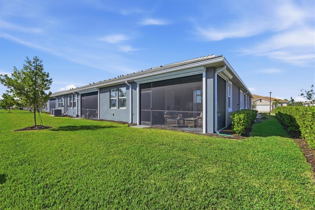 12333 Asana Court Venice, FL 34293 - Photo 30 of 58 a view of a house with backyard and garden