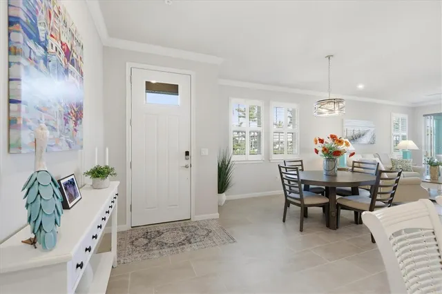 a view of a dining room with furniture and chandelier
