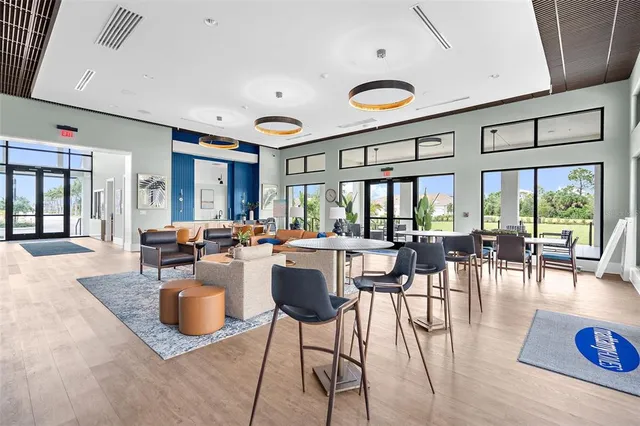 a dining area with furniture and a large window