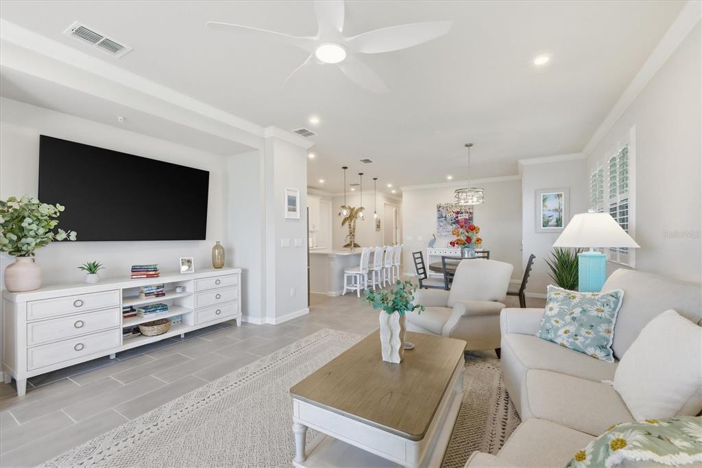12333 Asana Court Venice, FL 34293 - Photo 7 of 58 a living room with furniture and a flat screen tv