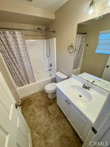 a bathroom with a sink mirror vanity and toilet