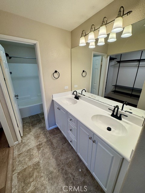 41685 Woodridge Avenue, Unit 2 Murrieta, CA 92562 - Photo 14 of 22 a spacious bathroom with a double vanity sink and a mirror