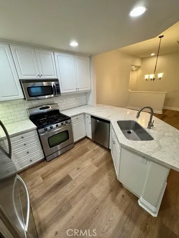 a kitchen that has a sink and a stove