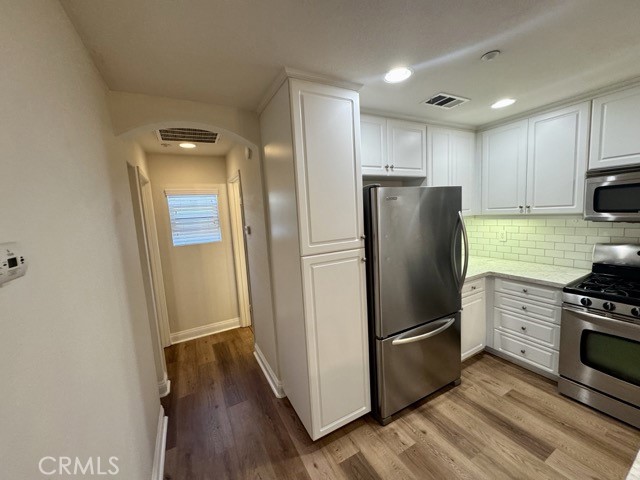 41685 Woodridge Avenue, Unit 2 Murrieta, CA 92562 - Photo 8 of 22 a kitchen with stainless steel appliances granite countertop a refrigerator stove and sink