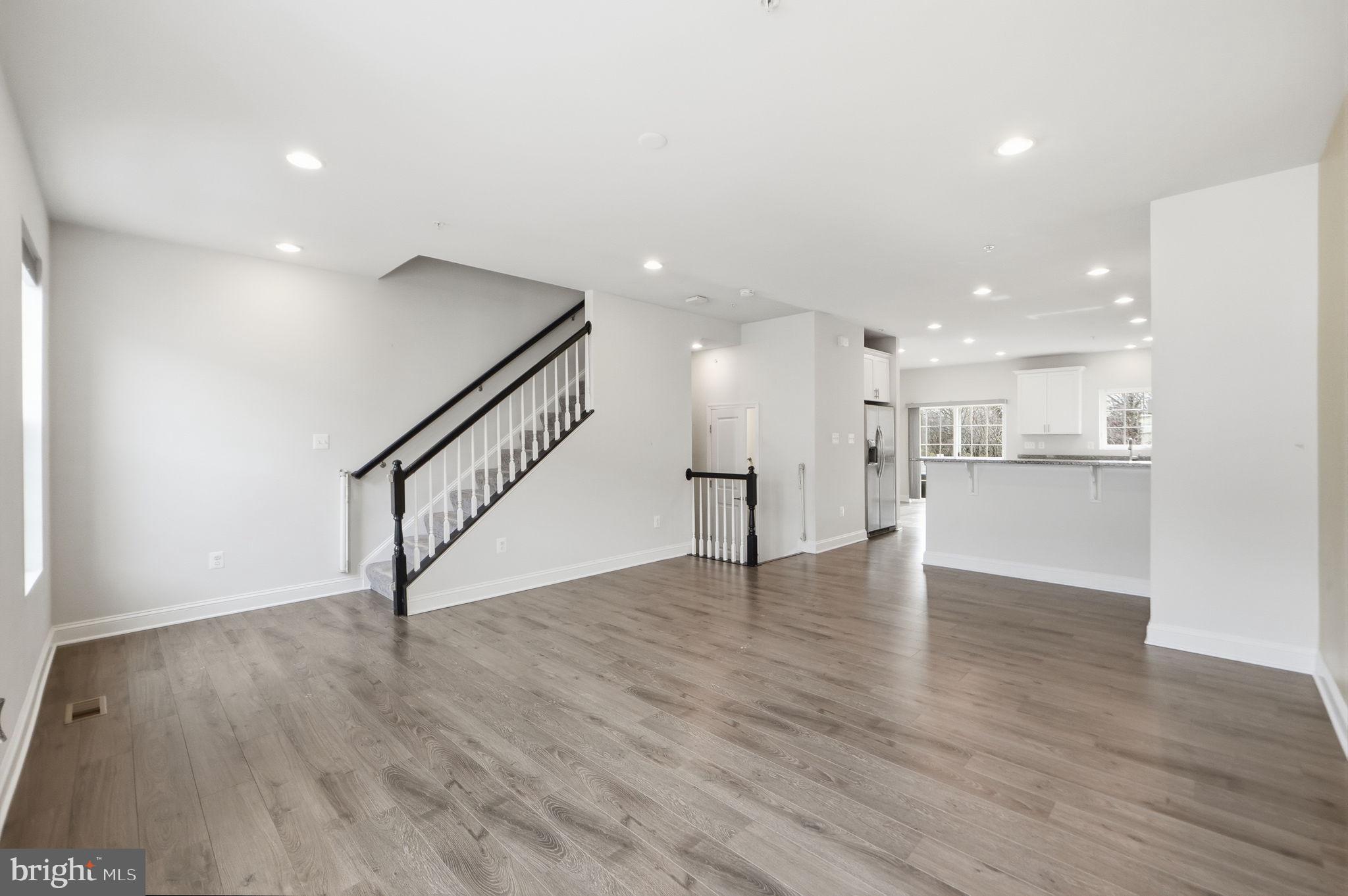 3623 Duckhorn Way Laurel, MD 20724 - Photo 14 of 48 a view of an empty room with wooden floor kitchen view and a window