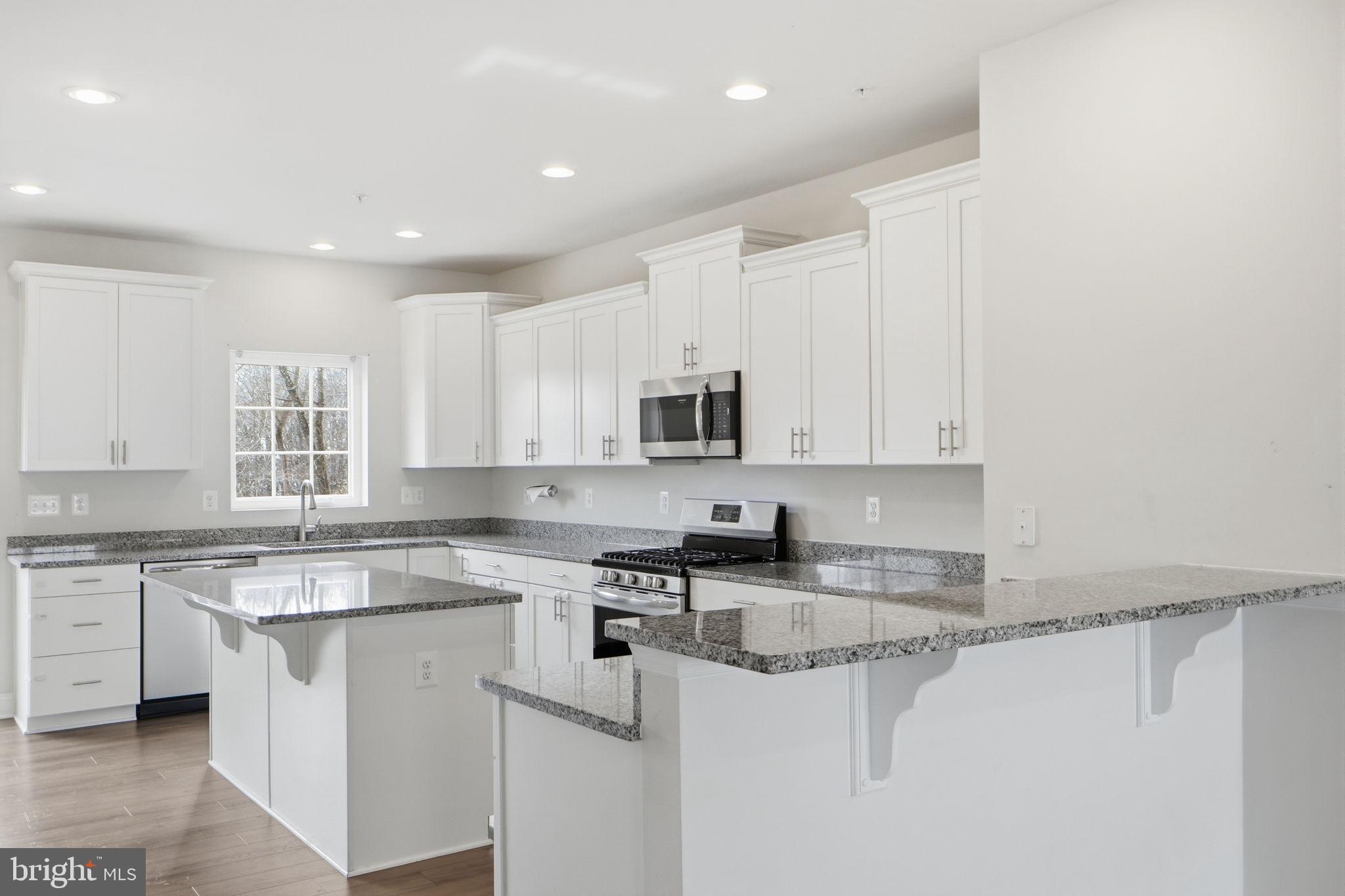 3623 Duckhorn Way Laurel, MD 20724 - Photo 18 of 48 a kitchen with stainless steel appliances granite countertop a sink stove and cabinets