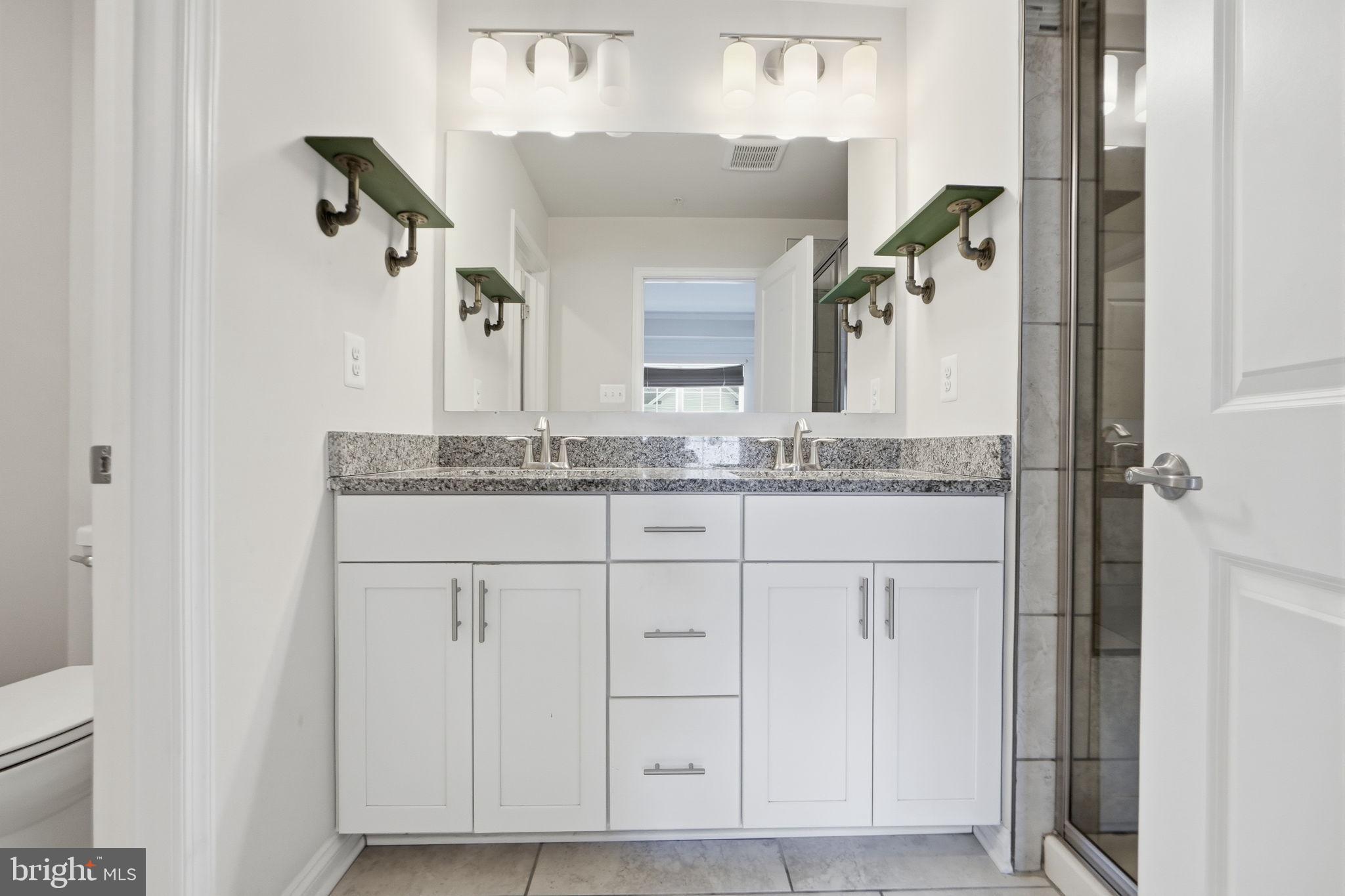 3623 Duckhorn Way Laurel, MD 20724 - Photo 28 of 48 a bathroom with a granite countertop sink and a mirror
