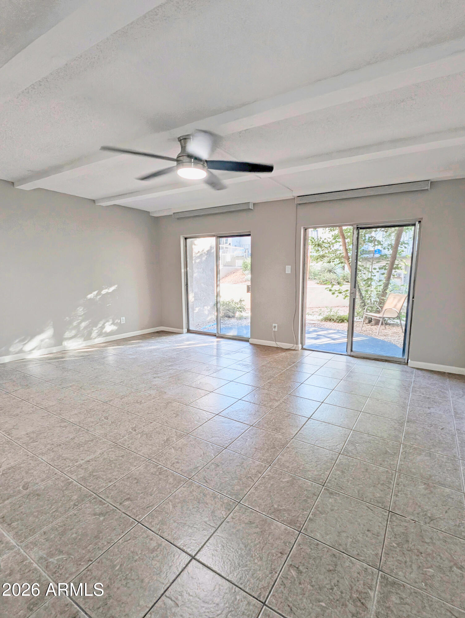 1018 East Osborn Road, Unit A Phoenix, AZ 85014 - Photo 4 of 19 wooden floor in an empty room with a window