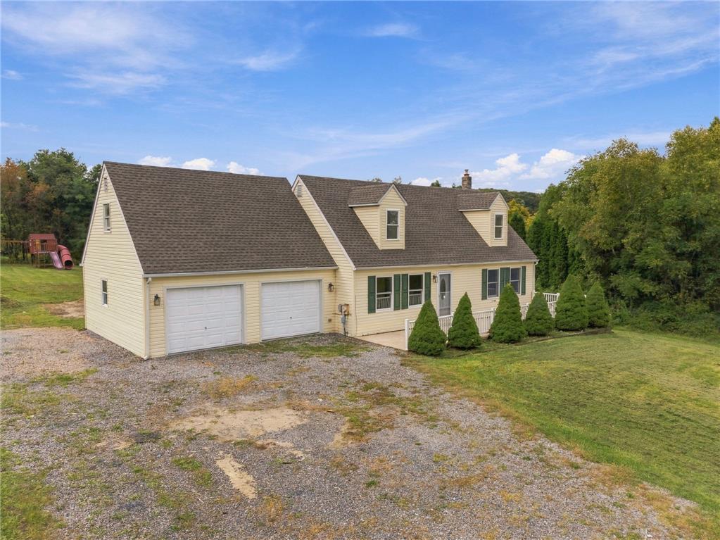90 Gun Club Road Palmerton, PA 18071 - Photo 6 of 58 An attached two-car garage sits beside this multi-level home with traditional siding and dormers.