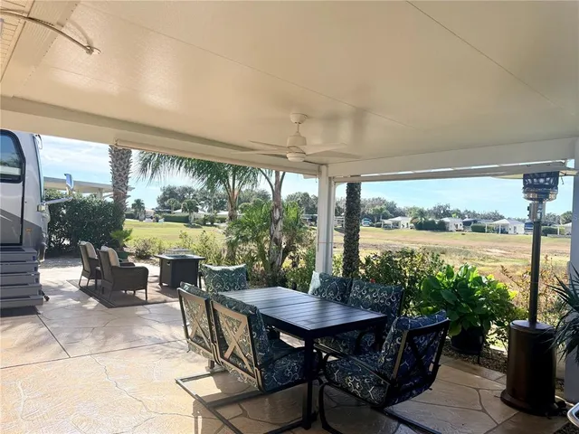 a view of a patio with table and chairs potted plants with sky view