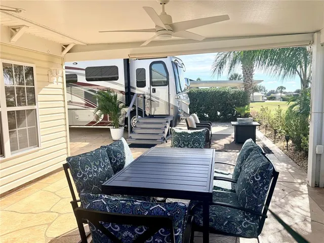 a view of a patio with table and chairs with wooden floor and outdoor seating