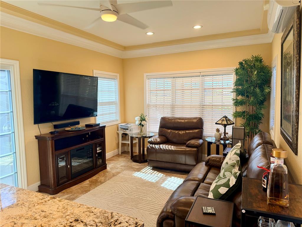 9516 Southeast 47th Way Webster, FL 33597 - Photo 20 of 43 a living room with furniture and a flat screen tv