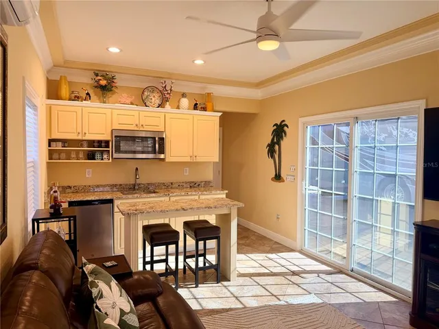 a open kitchen with stainless steel appliances granite countertop a stove and a refrigerator