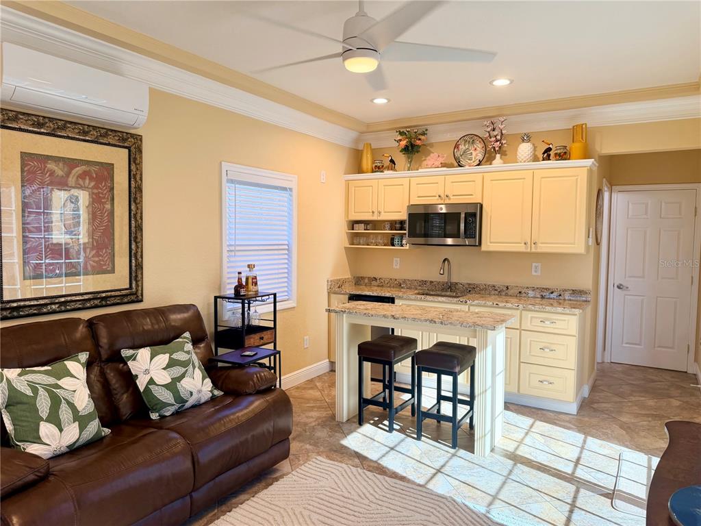 9516 Southeast 47th Way Webster, FL 33597 - Photo 23 of 43 a living room with furniture a fireplace and a flat screen tv