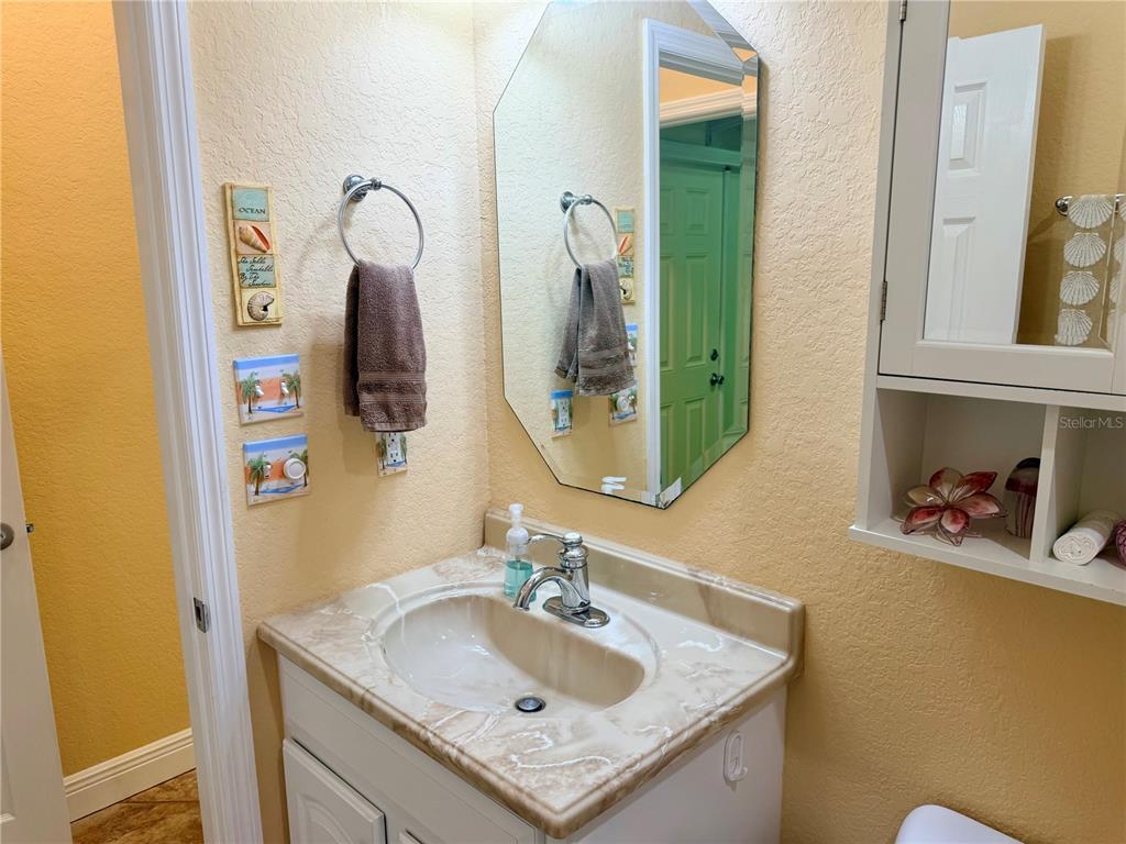 9516 Southeast 47th Way Webster, FL 33597 - Photo 27 of 43 a bathroom with a sink vanity and a mirror