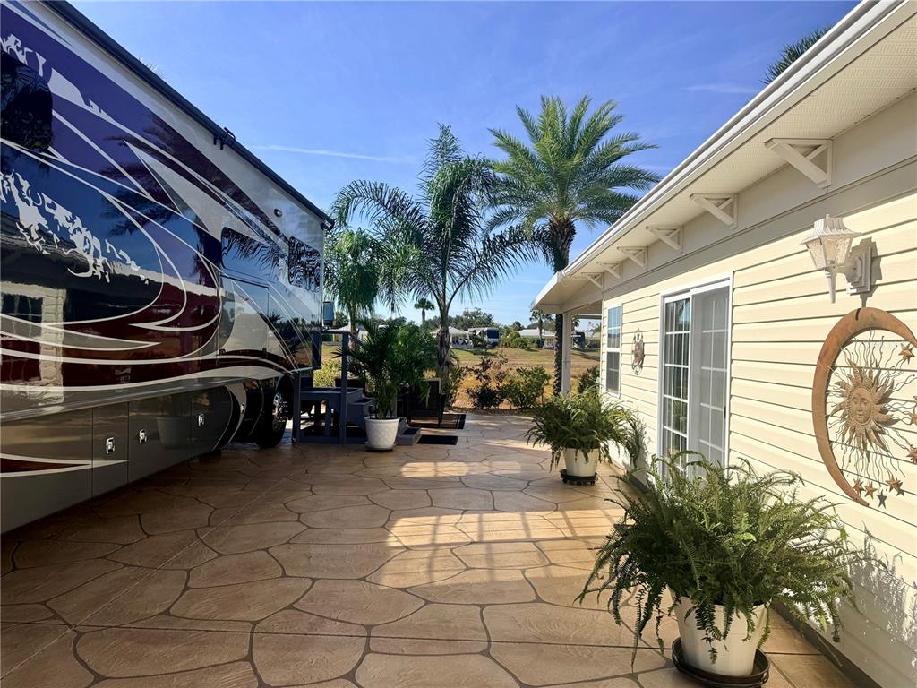 9516 Southeast 47th Way Webster, FL 33597 - Photo 6 of 43 a view of a patio with table and chairs and potted plants