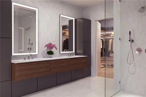 a bathroom with a double vanity sink shower and mirror