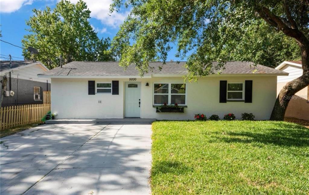 a backyard of a house with table and chairs