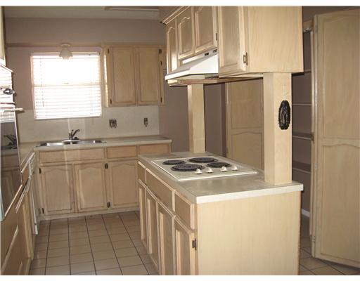 4609 Weiskopf Circle Corpus Christi, TX 78413 - Photo 2 of 6 a kitchen with granite countertop a sink stove and cabinets