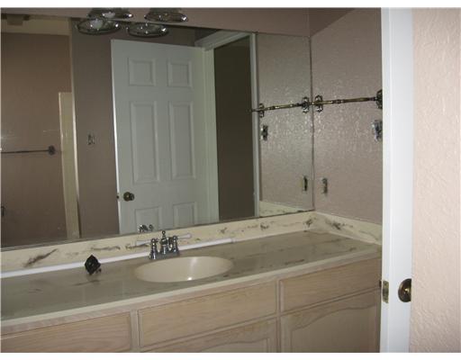4609 Weiskopf Circle Corpus Christi, TX 78413 - Photo 6 of 6 a bathroom with a tub sink and mirror
